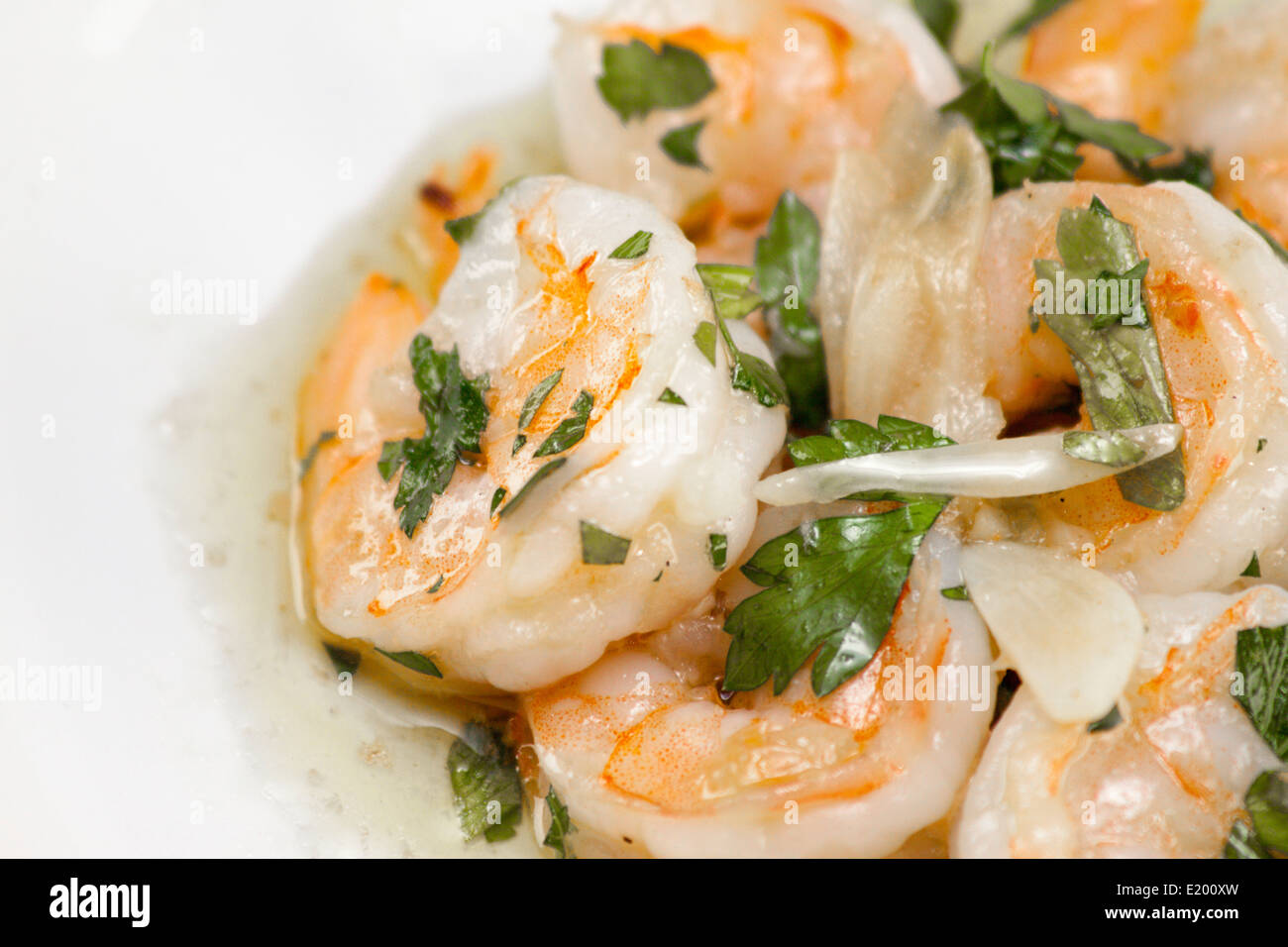 Close up of coked shrimp in olive oil seasoned with garlic and parsley. Stock Photo