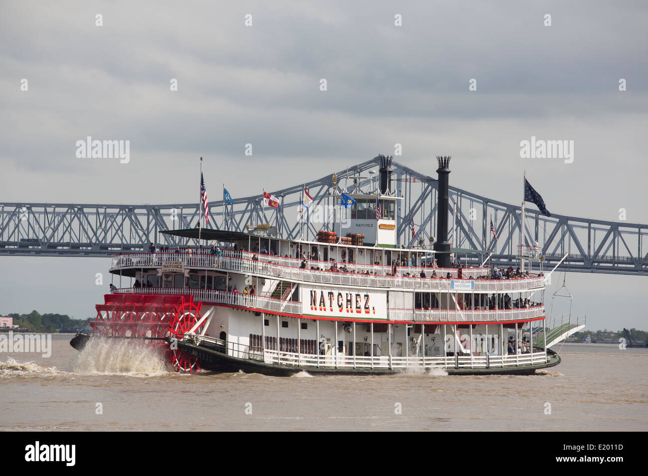 Natchez river boat is seen on the Mississippi River in New Orleans with a bridge in the background. Stock Photo