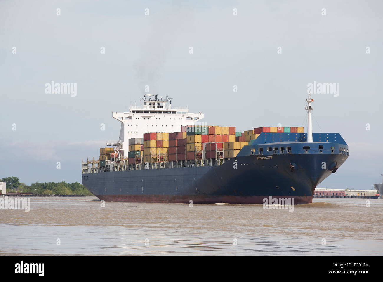 A cargo ship loaded with containers is seen on the Mississippi River. Stock Photo