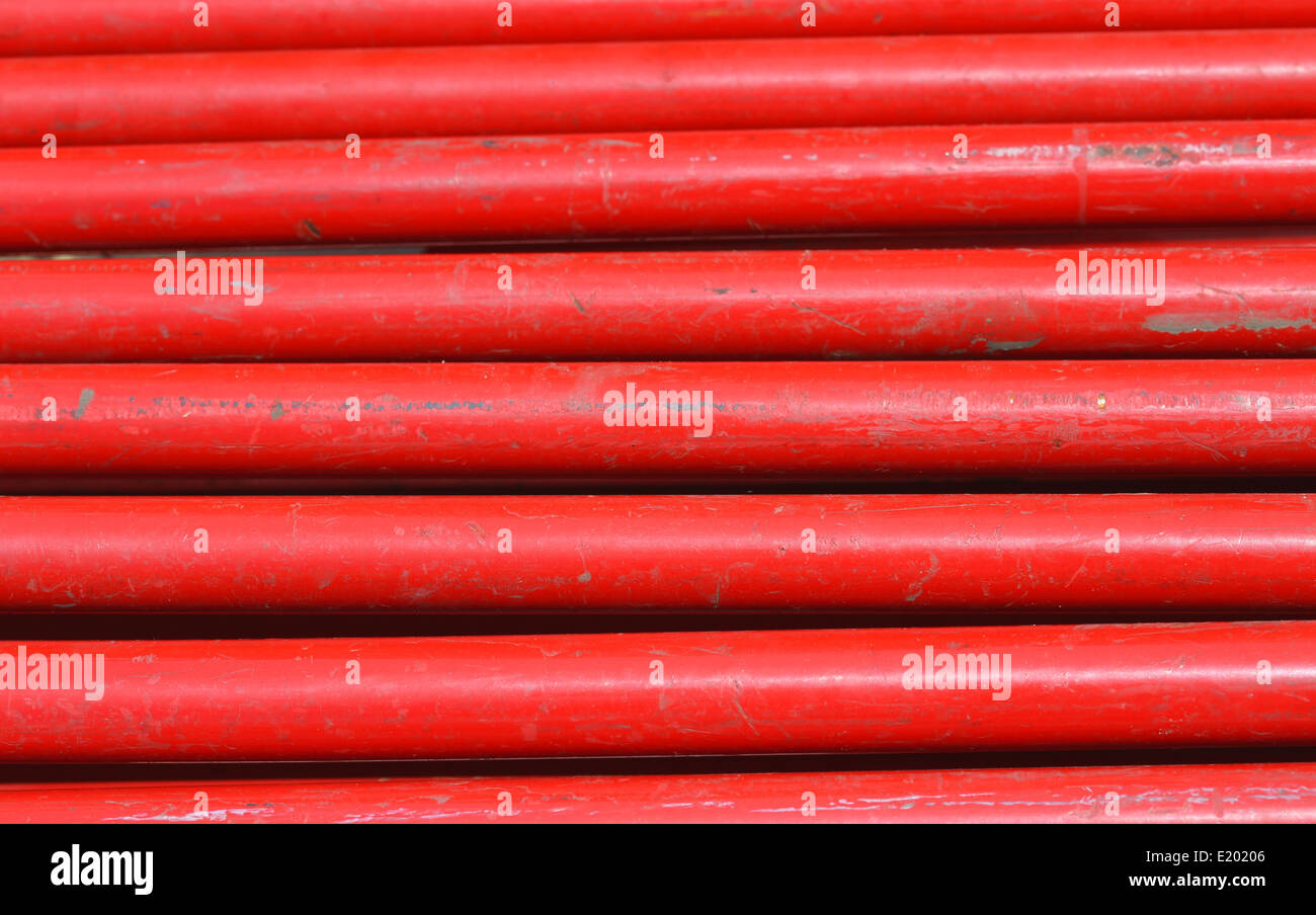 uniform background of red iron horizontal tubes Stock Photo