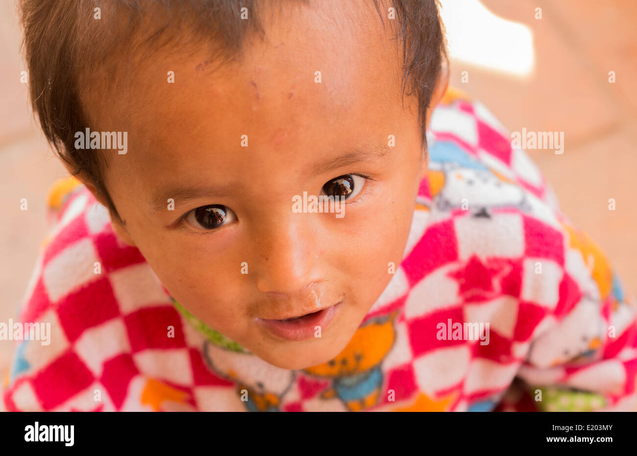 Kathmandu Nepal a small Nepali child smiling in Nayapati, Eastern Kathmandu. 1 Stock Photo