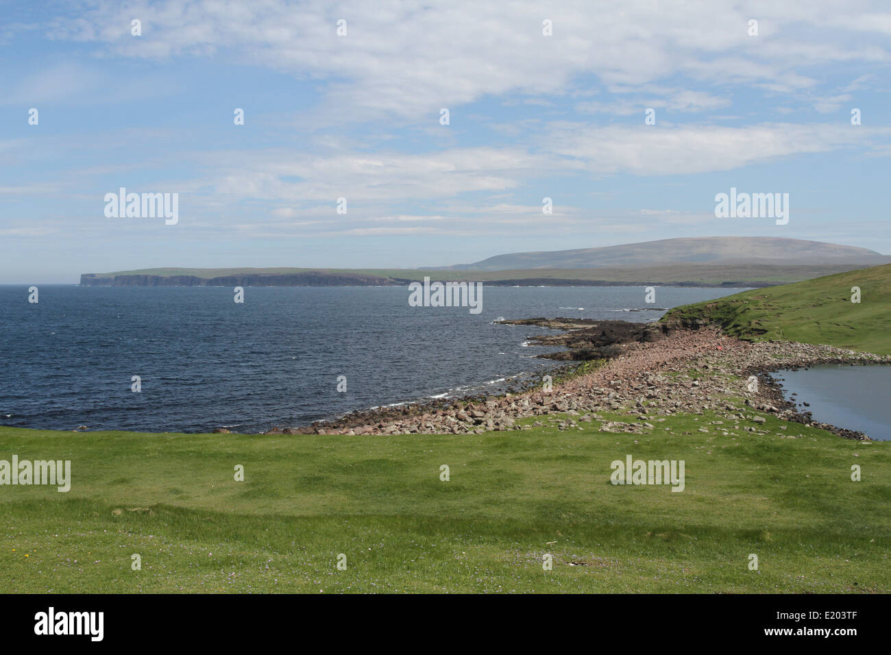 Coast with distant summit of Ronas Hill Northmavine Shetland Scotland  June 2014 Stock Photo