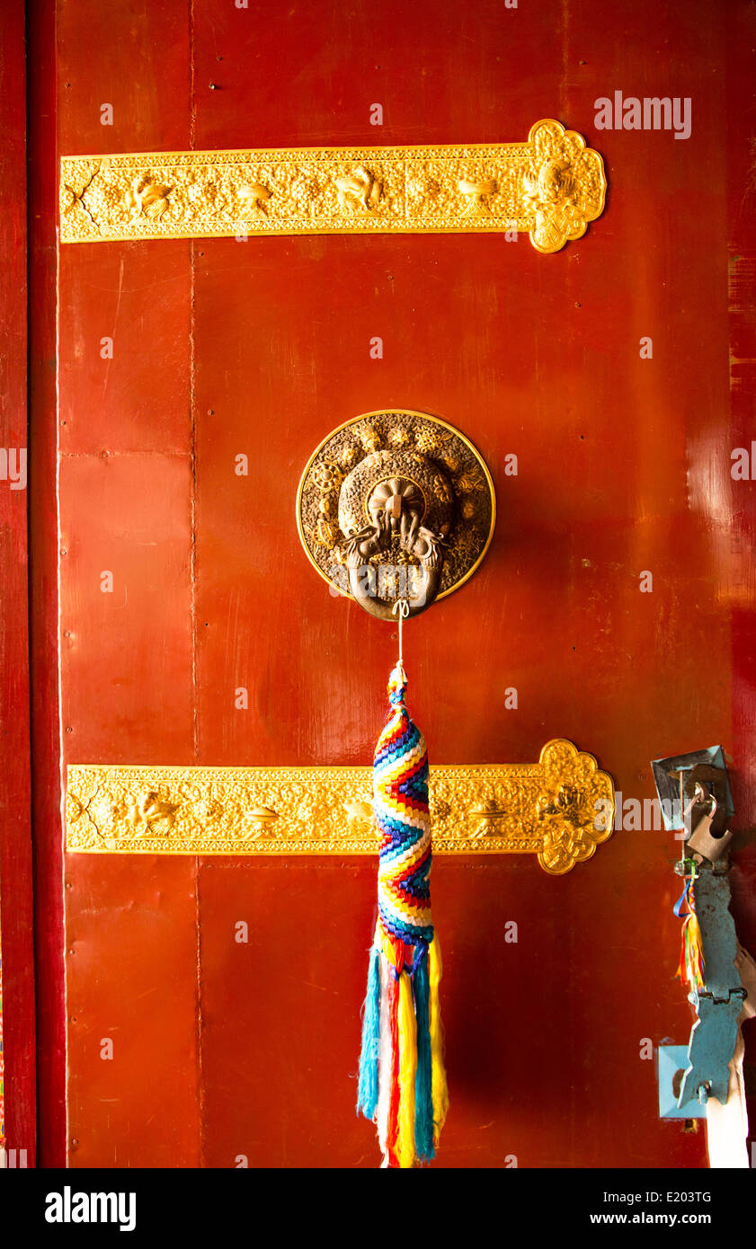 Kathmandu Nepal Door handle with colorful welcome thong hanging at the Drikung Kagyu Rinchenling monastery Eastern Kathmandu. Stock Photo