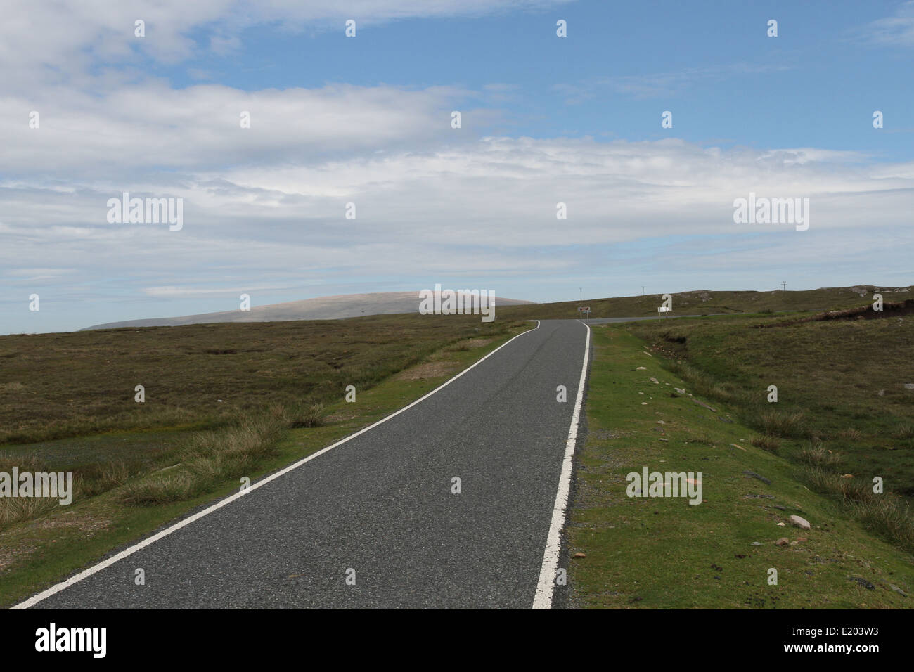 Road  with distant summit of Ronas Hill Northmavine Shetland Scotland  June 2014 Stock Photo
