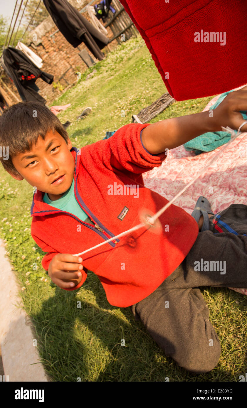 Kathmandu Nepal Nepali boy spinning toy wheel in Nayapati, Eastern