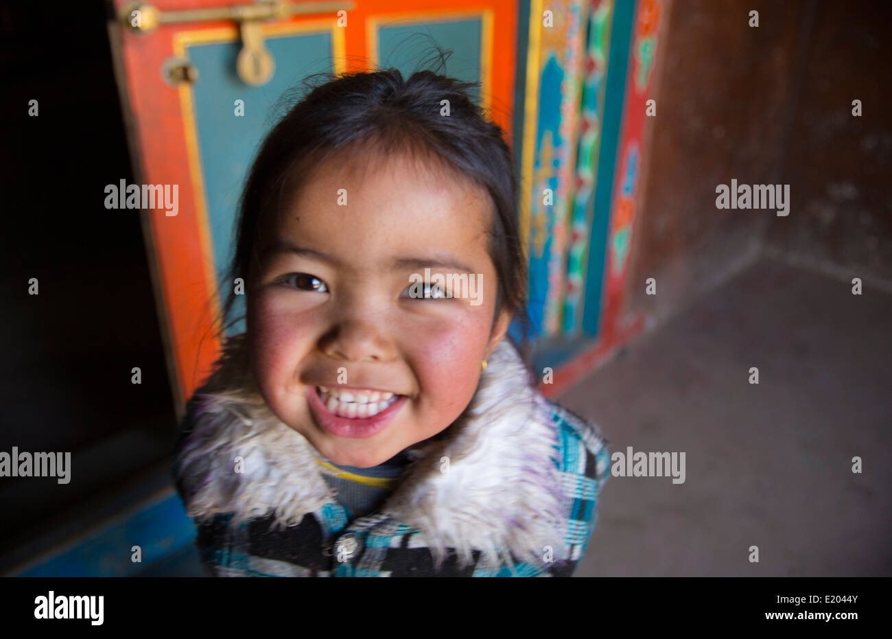 Lukla Nepal Young child pose in front of shrine and prayer wheel in Lukla Solukhumbu 56 Stock Photo