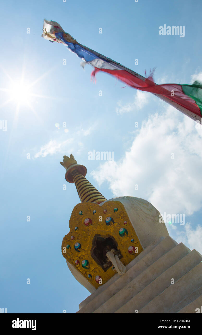 Nepal A stupa standing next to a prayer flag in the sun Solu Khumbu remote, Mt Everest, Himalayas, Stock Photo