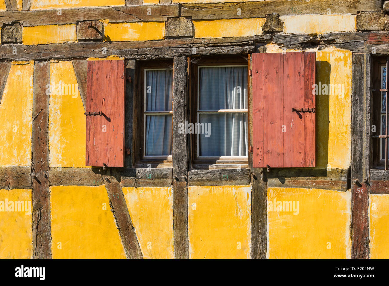 partial view of a yellow half-timbered house with wooden shutters, écomusée d´alsace, ungersheim, alsace, france Stock Photo