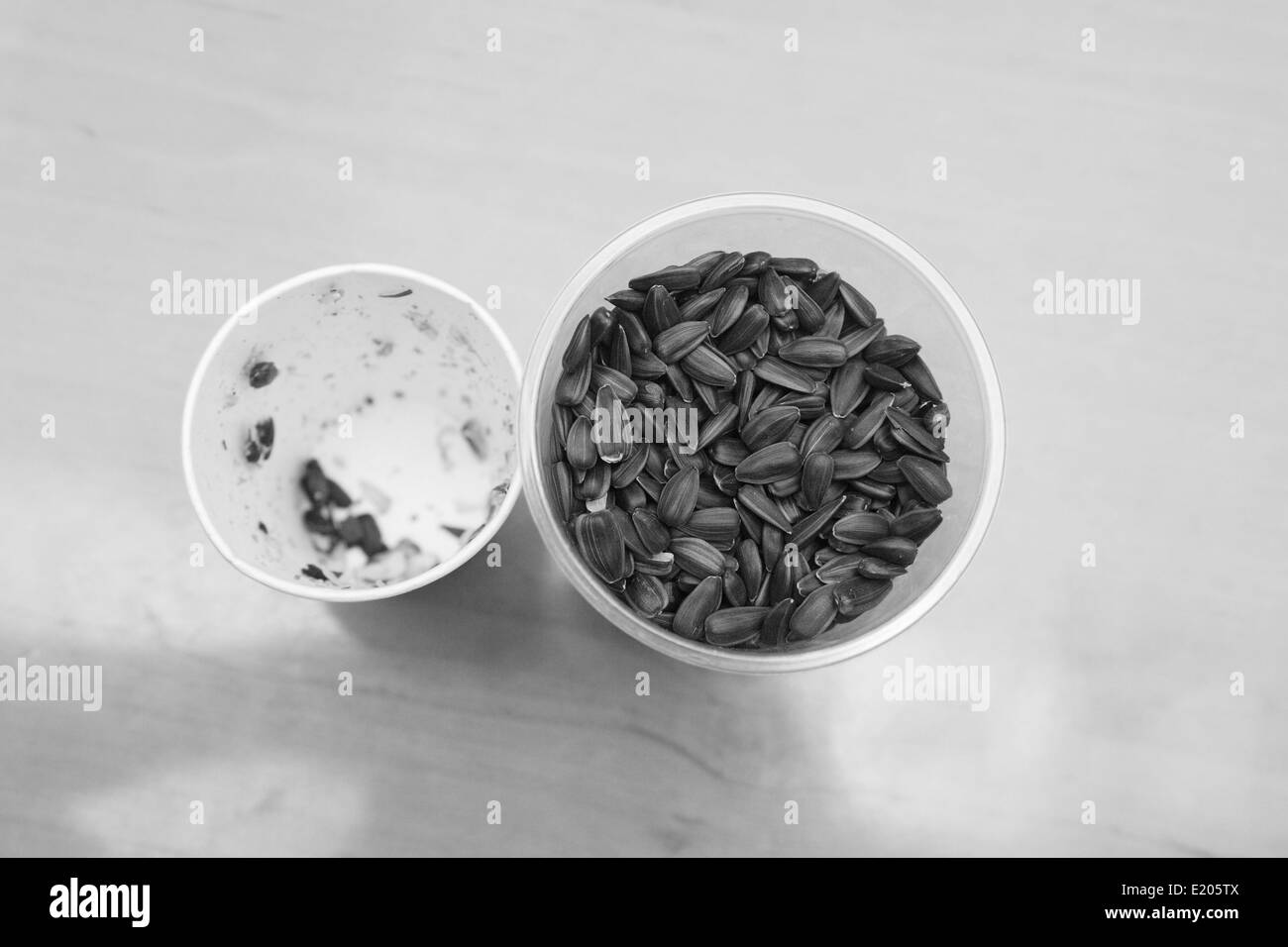 two glasses, one with seeds and another with husk Stock Photo