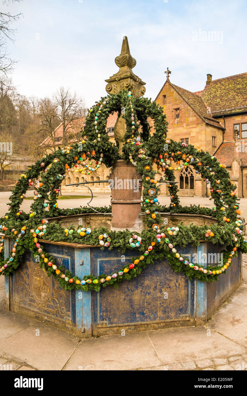 decorated so-called easter fountain displaying twigs and painted eggs, maulbron monastery, maulbronn, baden-wuerttemberg Stock Photo
