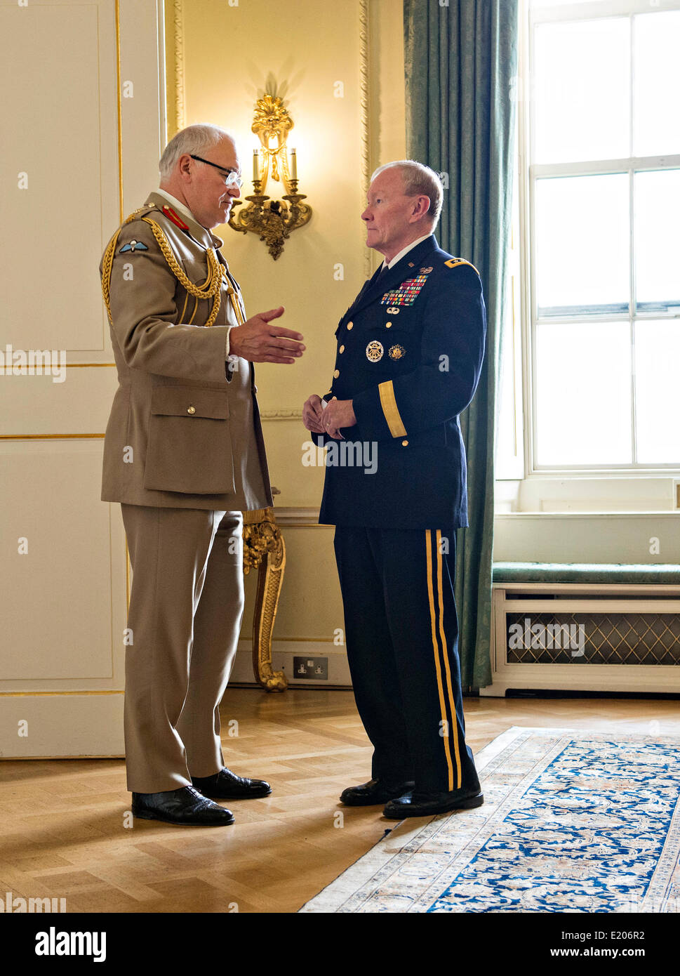 US Chairman of the Joint Chiefs Gen. Martin Dempsey, talks with U.K. Chief of General Staff Gen. Sir Peter Wall before a meeting with U.K. Prime Minister David Cameron as a part of a Defense Chiefs Strategic Dialog Group with US and UK defense chiefs June 10, 2014 in London, UK. Stock Photo