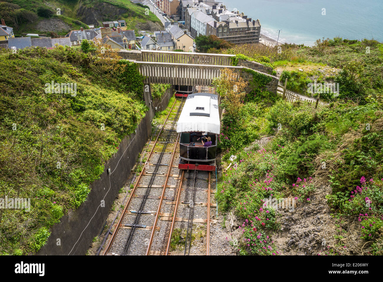 trains pass on the Constitution hill funicular railway Aberystwyth passing under a footbridge on their way up and down Stock Photo