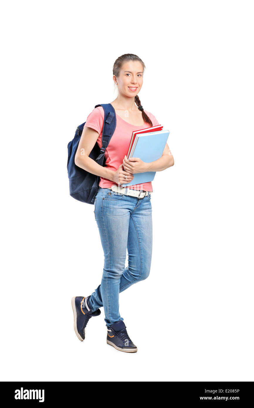 Full length portrait of a schoolgirl with backpack holding notebooks ...
