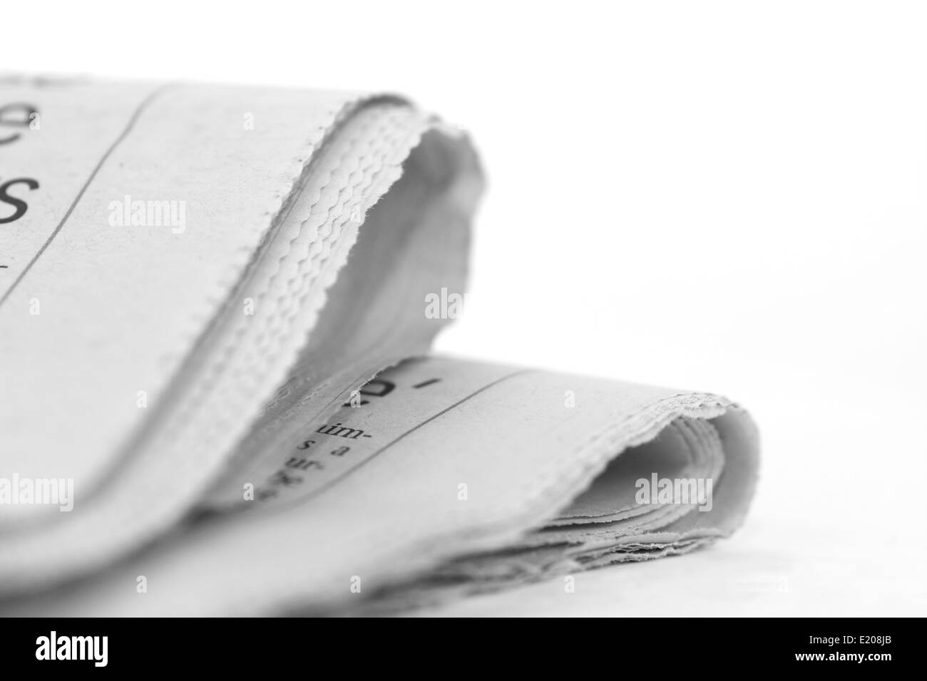 Newspaper folded up on a white background Stock Photo