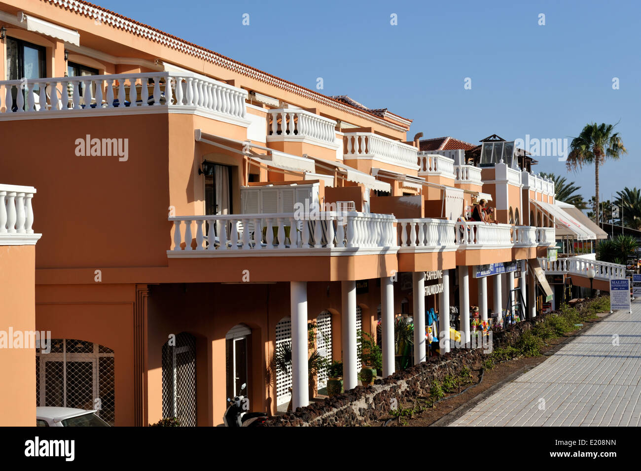 Hotel apartment balconies with shops below, Arona, Las Americas, Tenerife Stock Photo