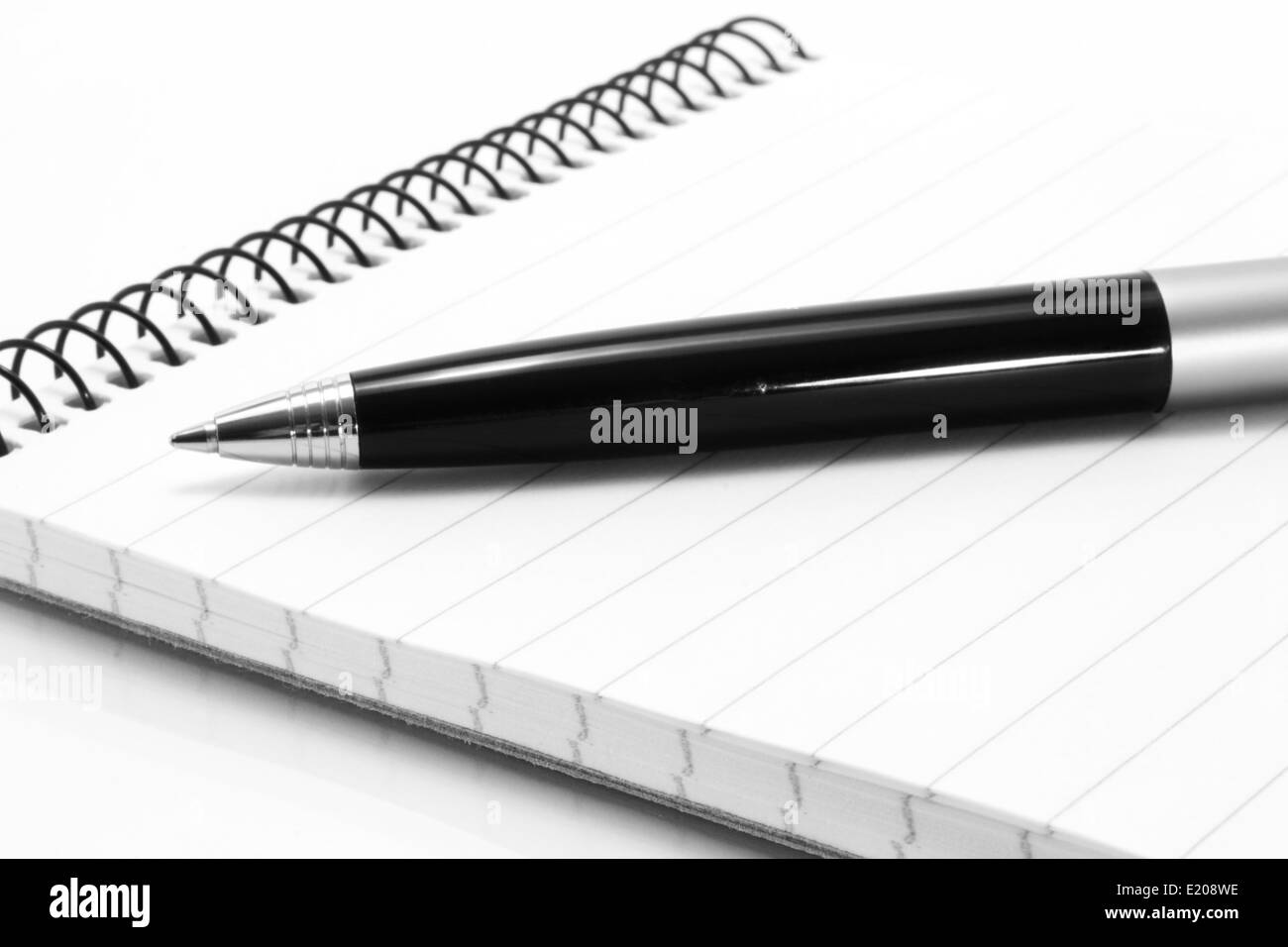 Notepad with ball pen on a white background Stock Photo
