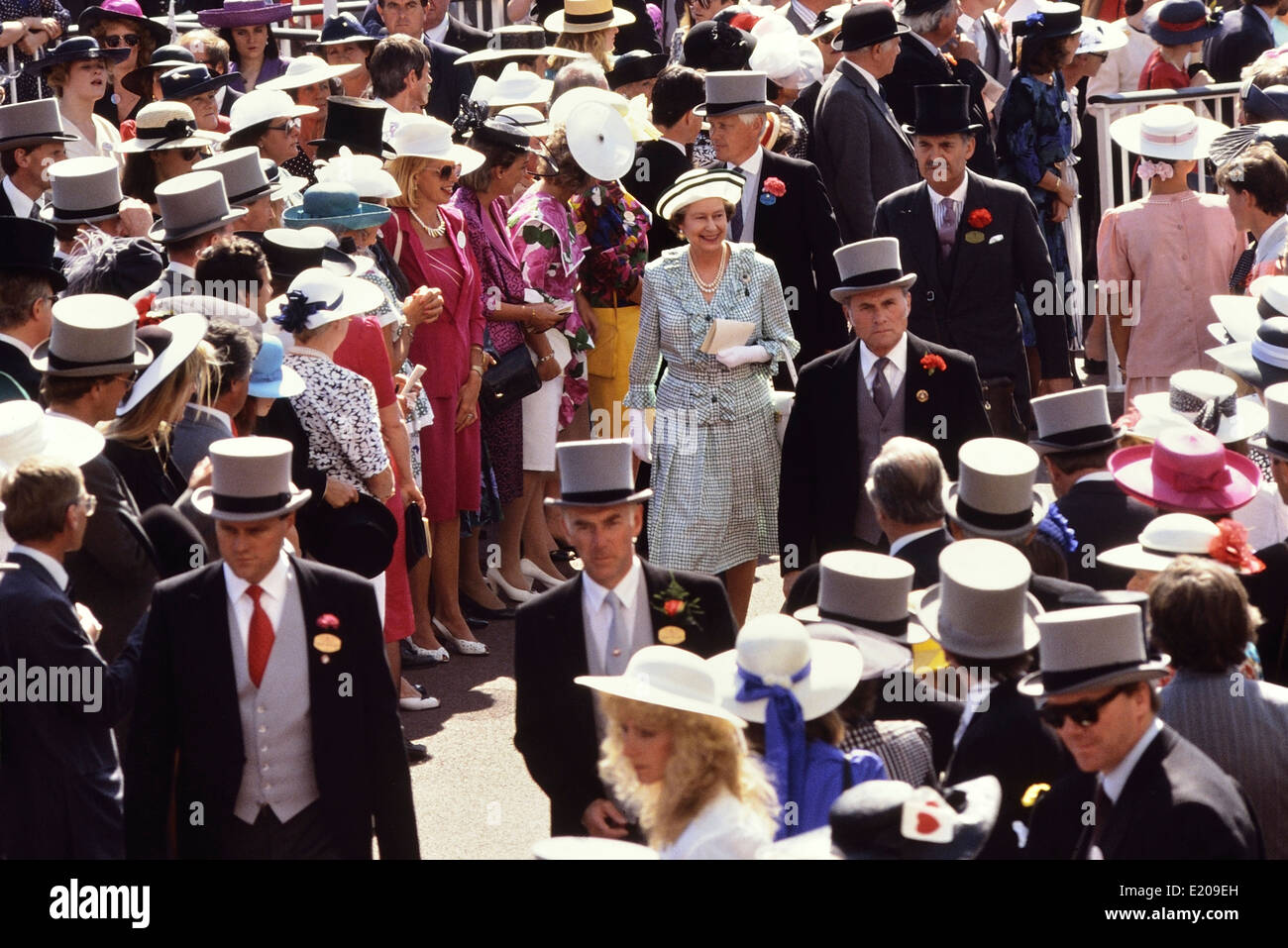 A smiling Queen Elizabeth II walking through the crowds race at Royal Ascot Races , Berkshire, England, UK. circa 1989 Stock Photo