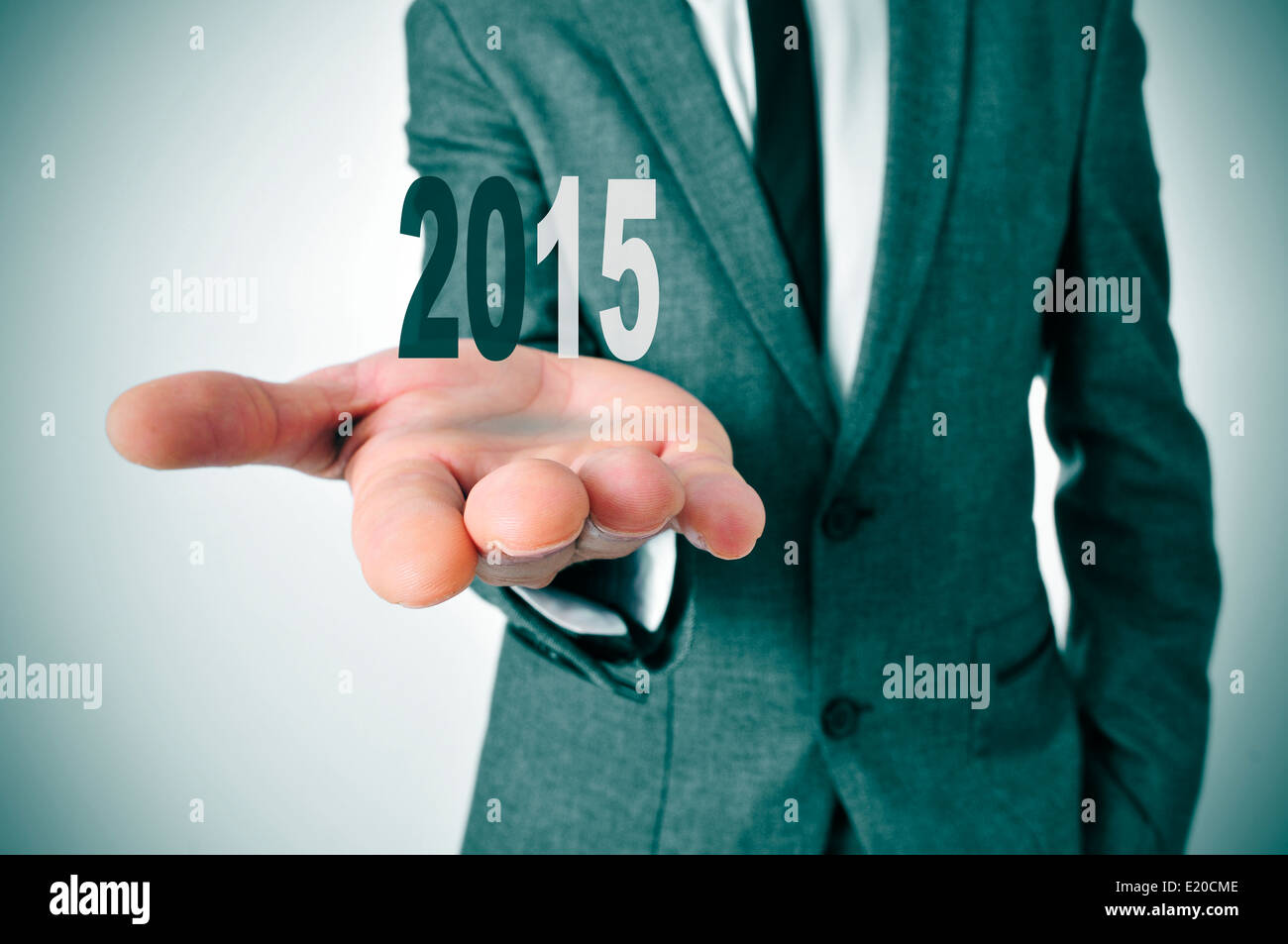 a businessman with the number 2015, as the new year, in his hand Stock Photo
