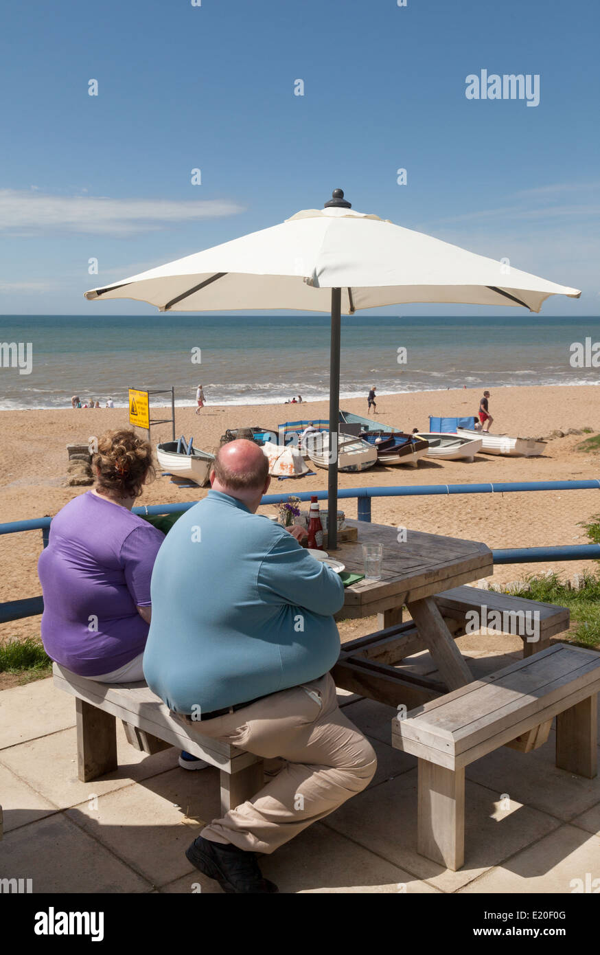 Obesity - Obese couple at the beach, UK Stock Photo