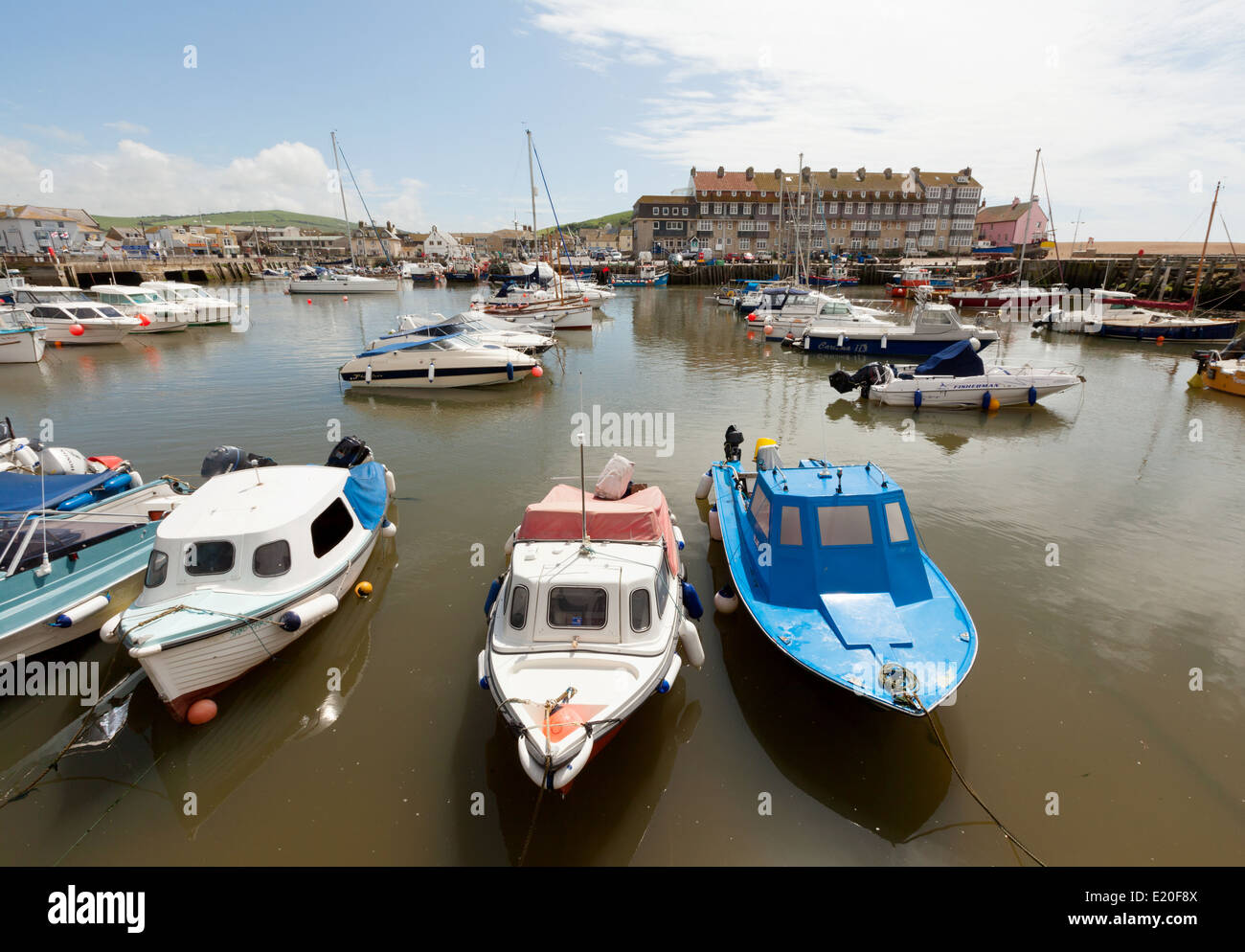 Small boats moored in West Bay, Bridport Harbour, Dorset coast England UK Stock Photo