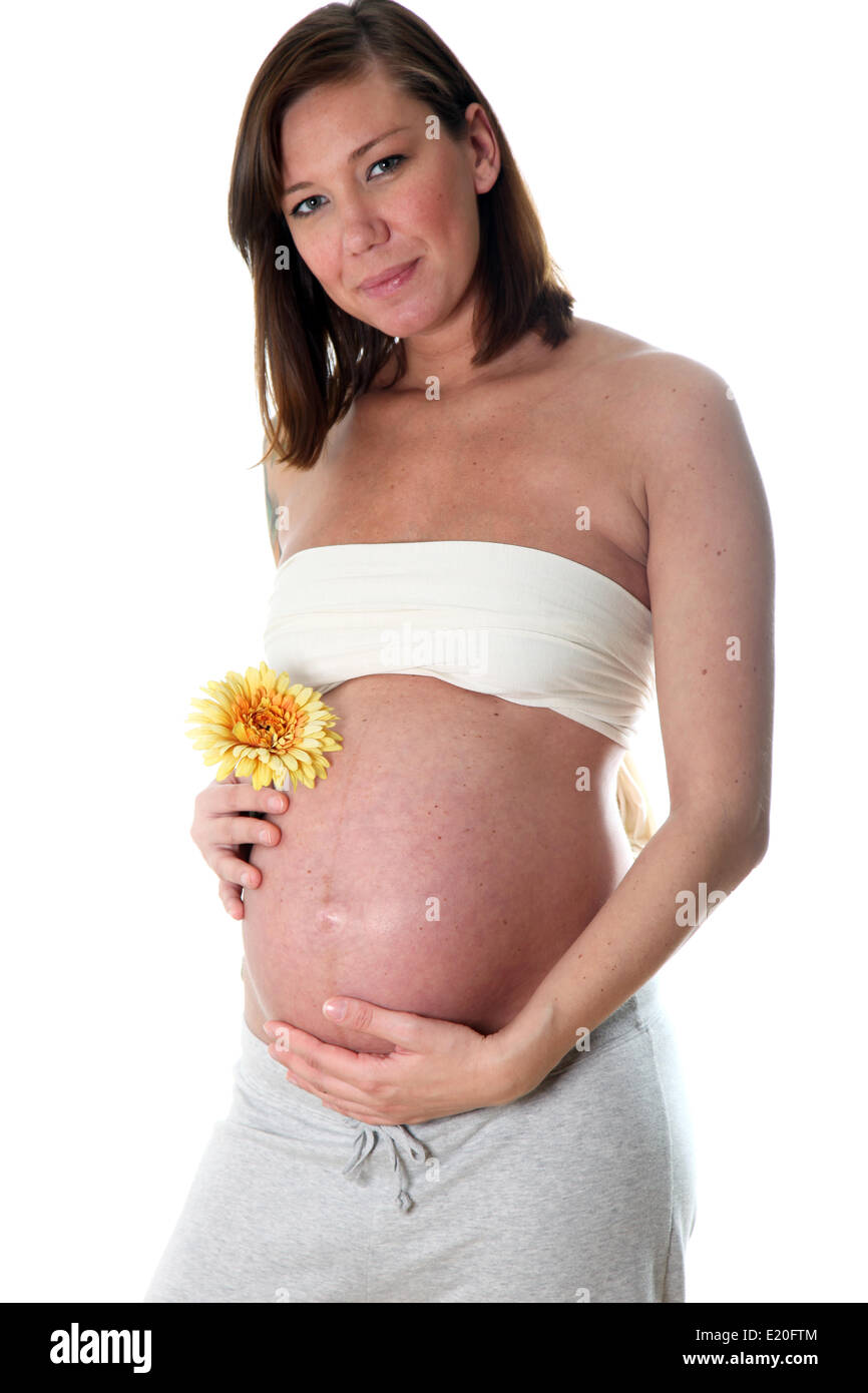 Smiling, very pregnant woman with baby belly Stock Photo