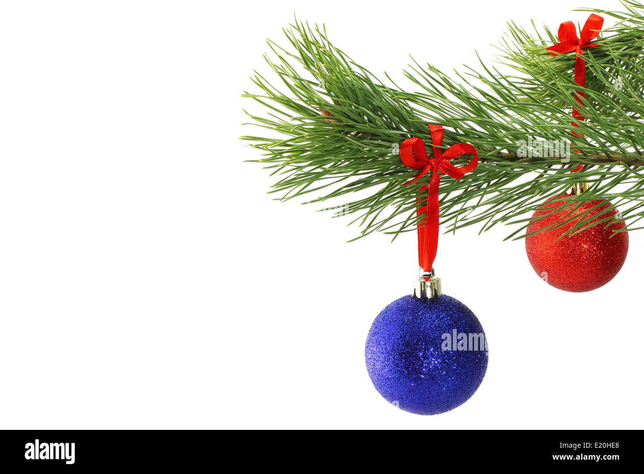 Christmas balls on fir tree branch on white background Stock Photo - Alamy