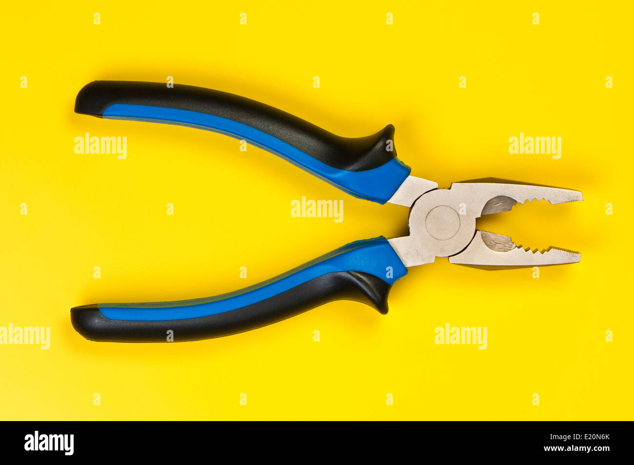 Pliers on a yellow background. Stock Photo