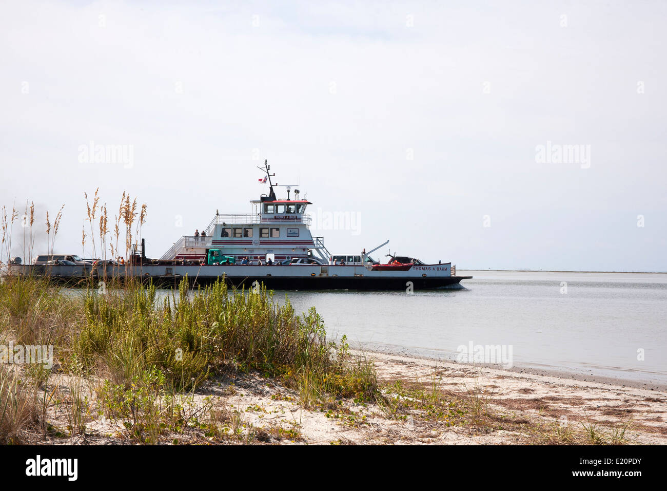 Sandy marshes of the barrier islands of the Outer Banks, North Carolina with a passing ferry