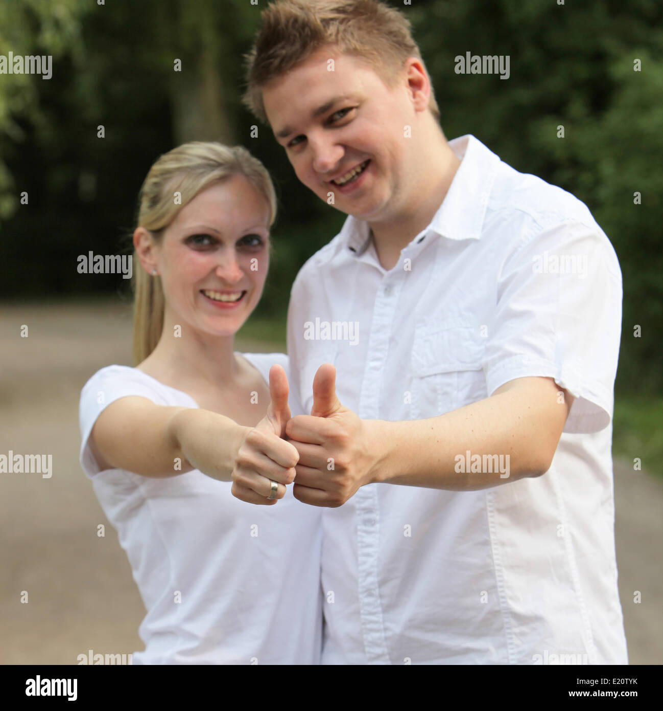 Young couple holding up the thumb Stock Photo