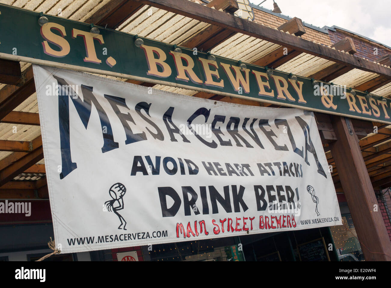 Cortez, Colorado - A sign outside the Main Street Brewery, a brew pub, advises people to 'avoid heart attacks - drink beer.' Stock Photo