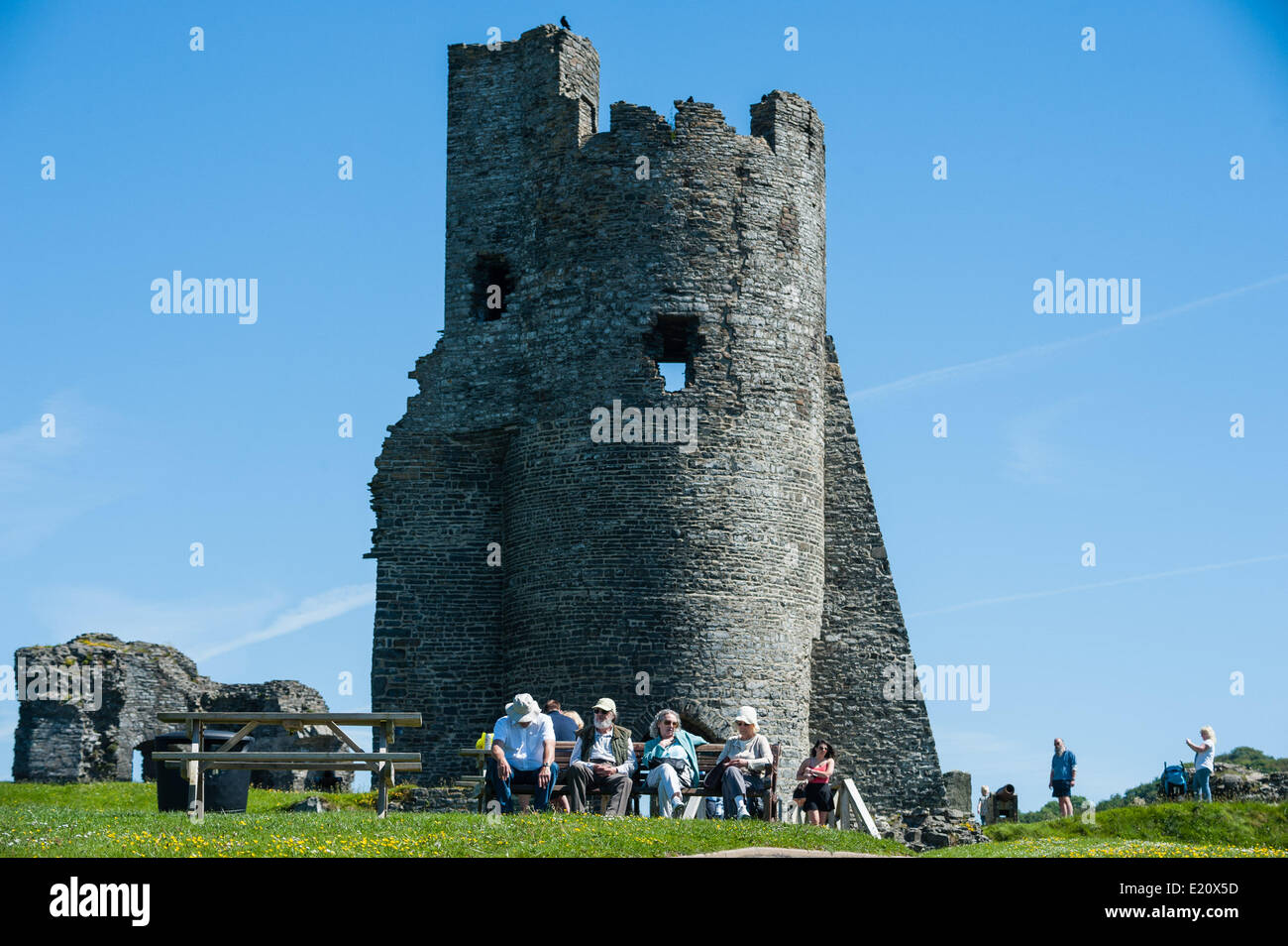 Aberystwyth Wales UK, Thursday 12 June 2014   With temperatures peaking at 18C  (64F) under clear blue skies,  people enjoy the warm sunny June weather by the ruined tower of  Aberystwyth castle on the west Wales coast UK.   Temperatures are forecast to rise by 2-3 degrees again tomorrow, before more unsettled weather moves in over the weekend  photo ©keith morris Stock Photo