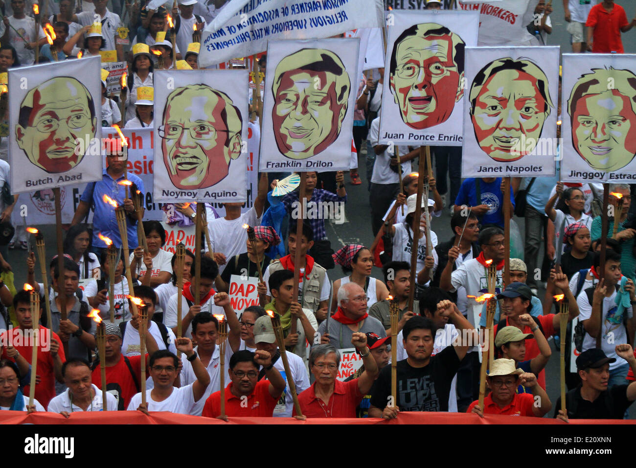 Manila, Philippines. 12th June, 2014. Activists hold torches and