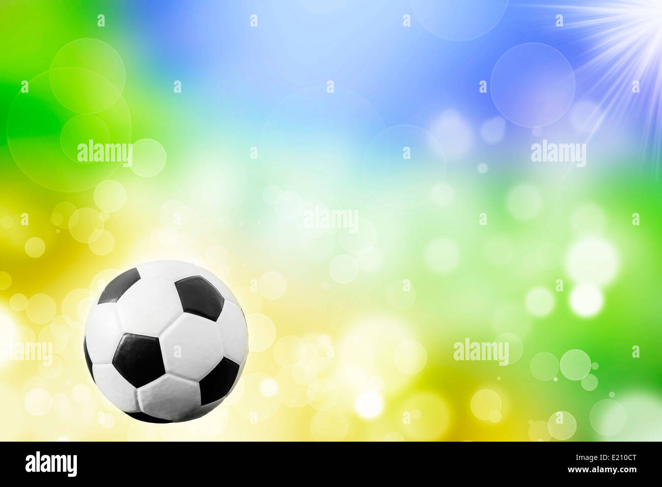 Soccer ball on blue, yellow and green background representing the