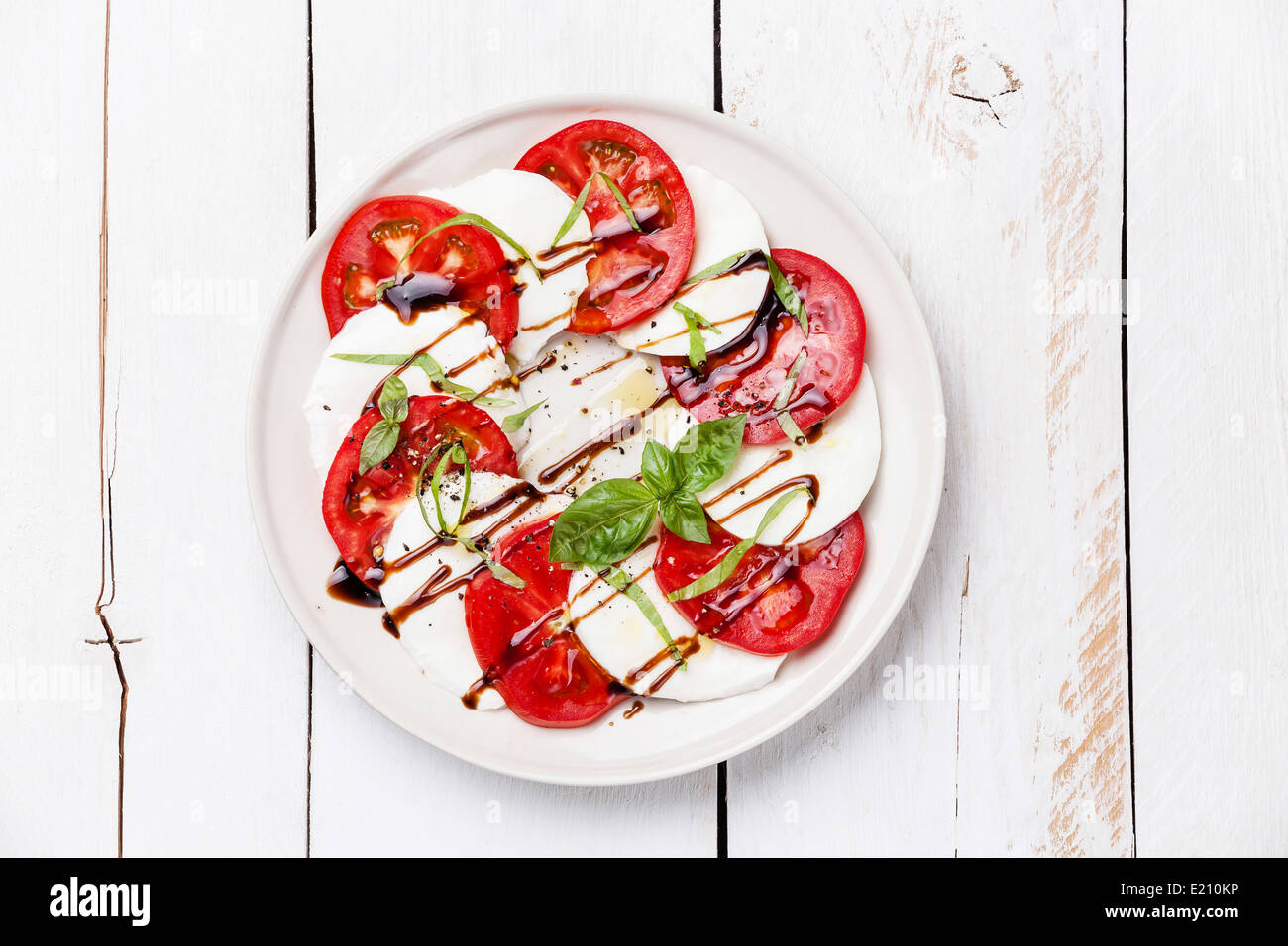 Caprese salad Tomato and mozzarella slices with basil leaves on white ...