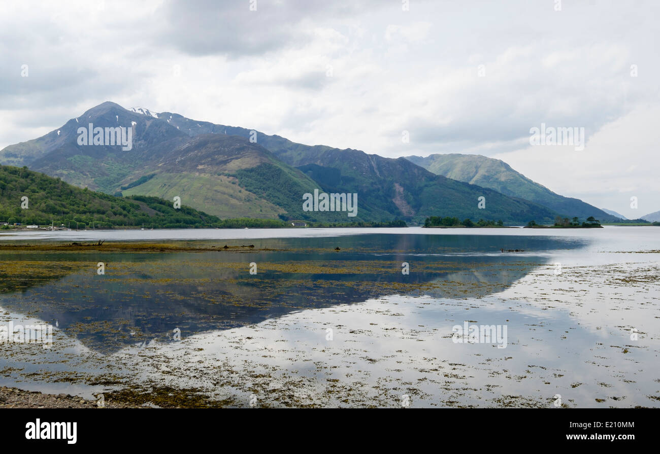 View across calm sea Loch Leven to mountains at high tide from Invercoe, Glencoe, Highland, Scotland, UK, Britain Stock Photo
