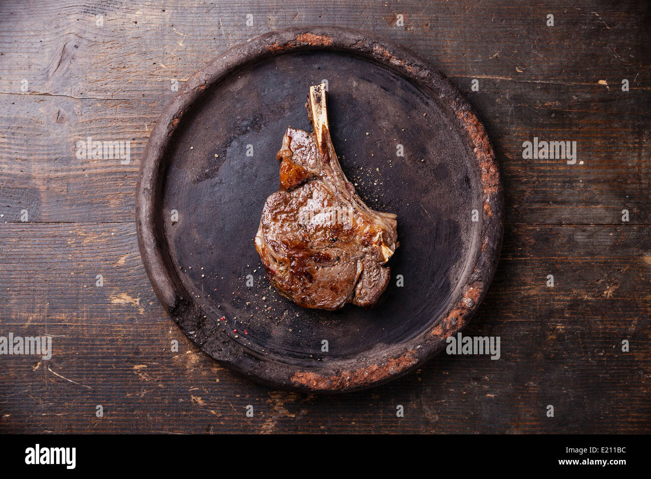 Ribeye Steak with salt and pepper on dark wooden background Stock Photo