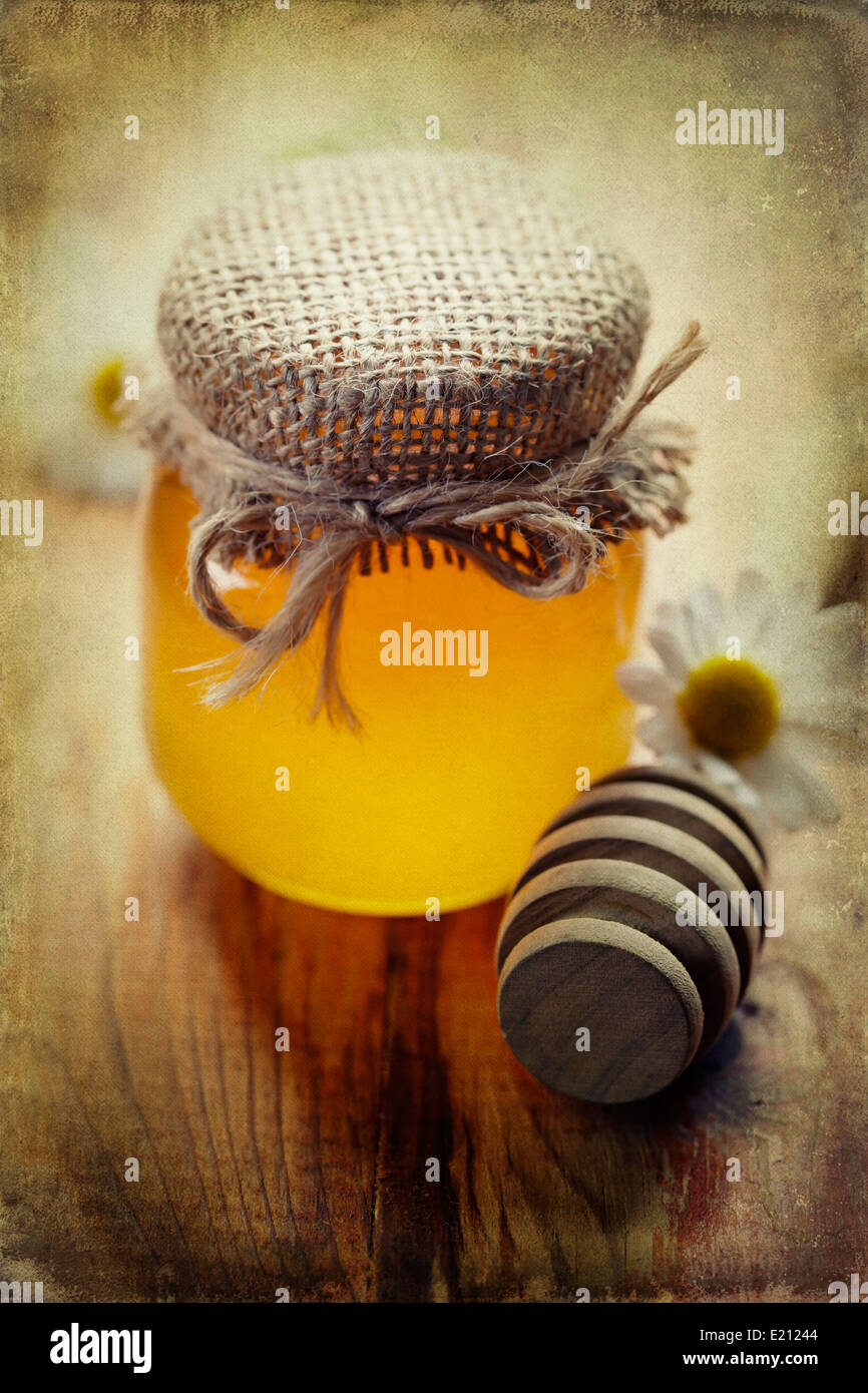 Full honey pot and honey stick Stock Photo Alamy