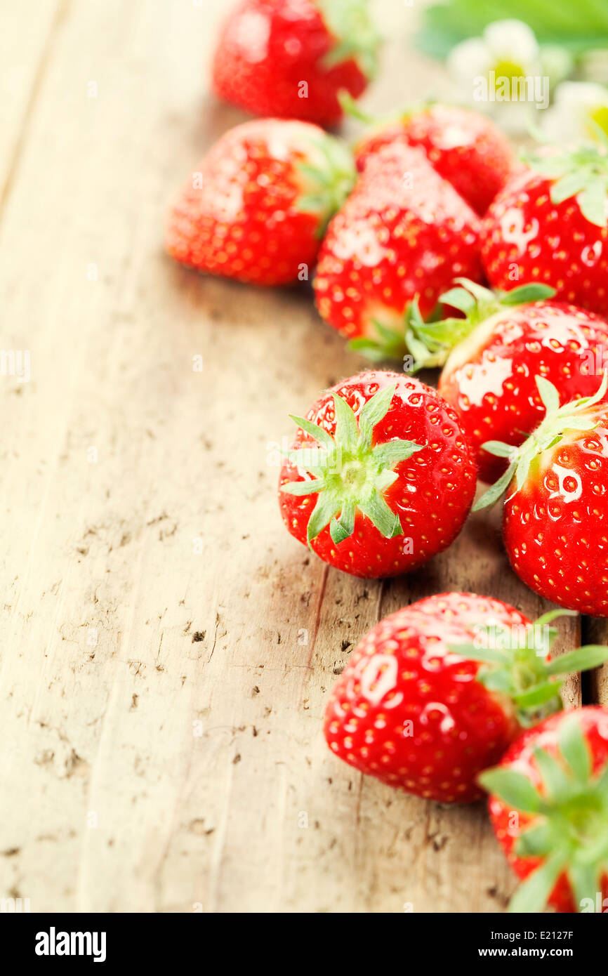 fresh red strawberries on wooden table top Stock Photo - Alamy