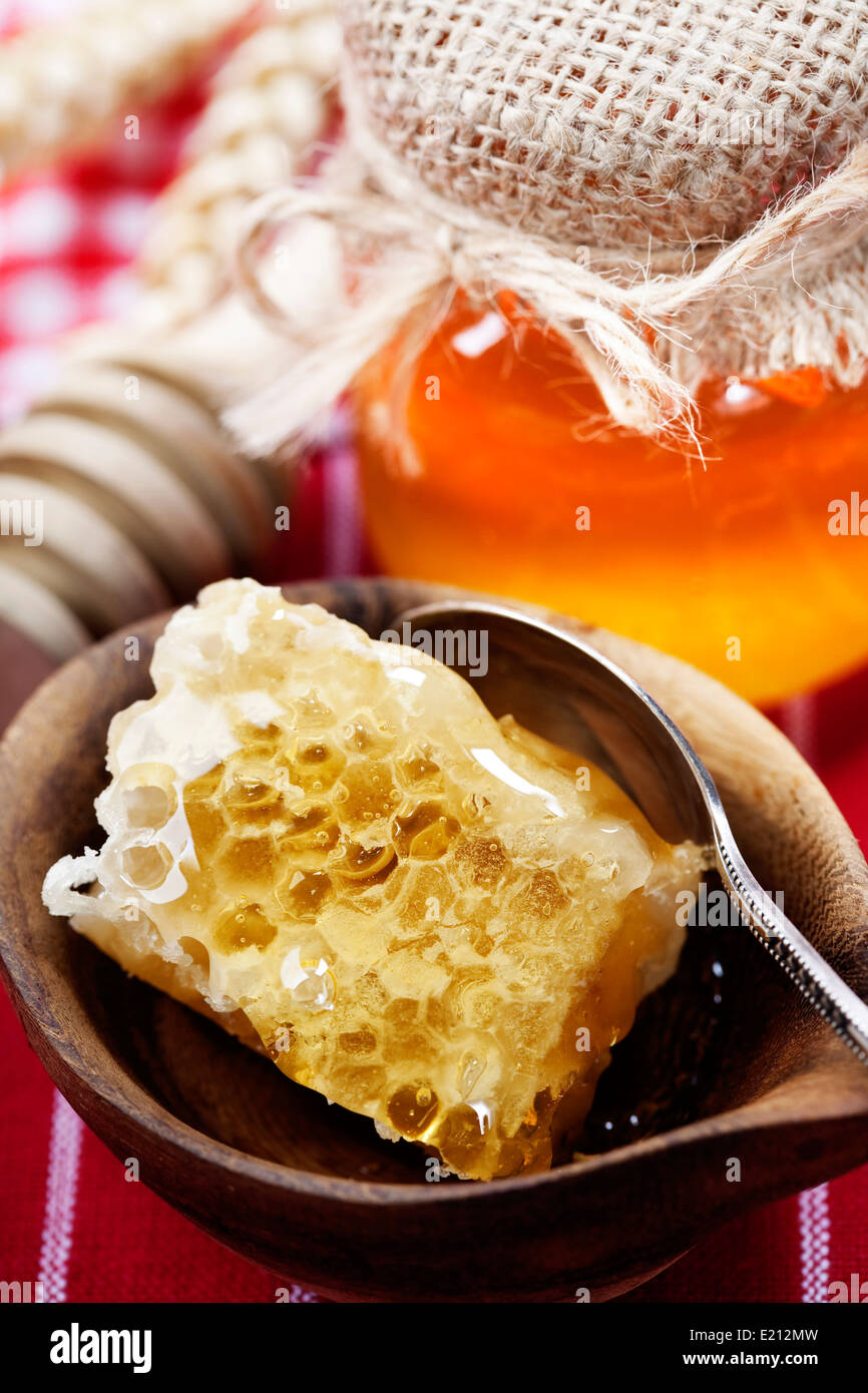 Beautiful honey comb, spoon and honey in jar Stock Photo - Alamy