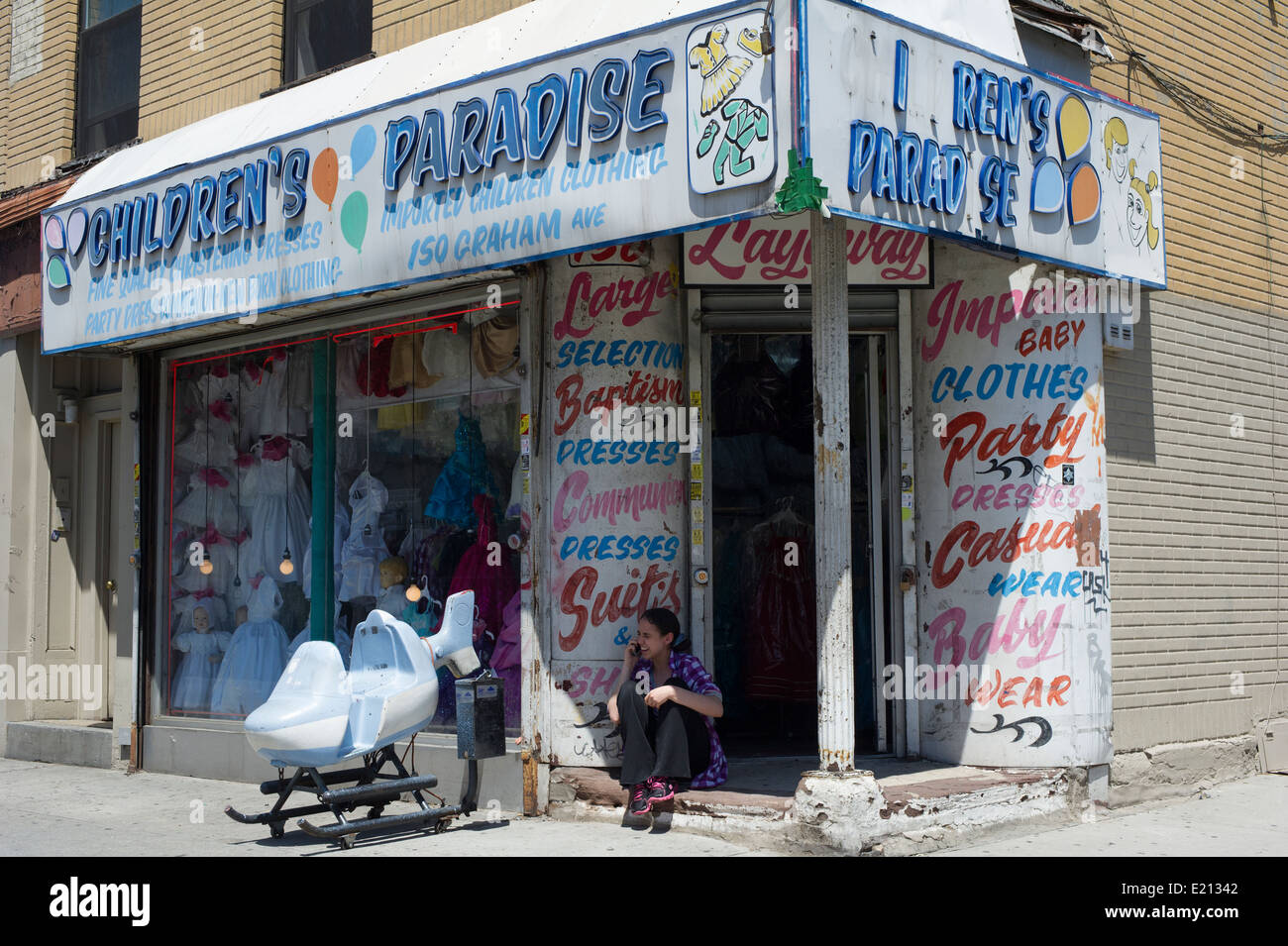 A children's clothing store on busy Graham Avenue in the Bushwick neighborhood of Brooklyn in New York Stock Photo