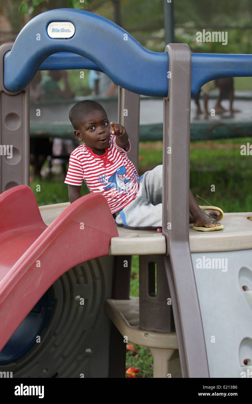 A young Zambian orphan on a jungle gym. Stock Photo