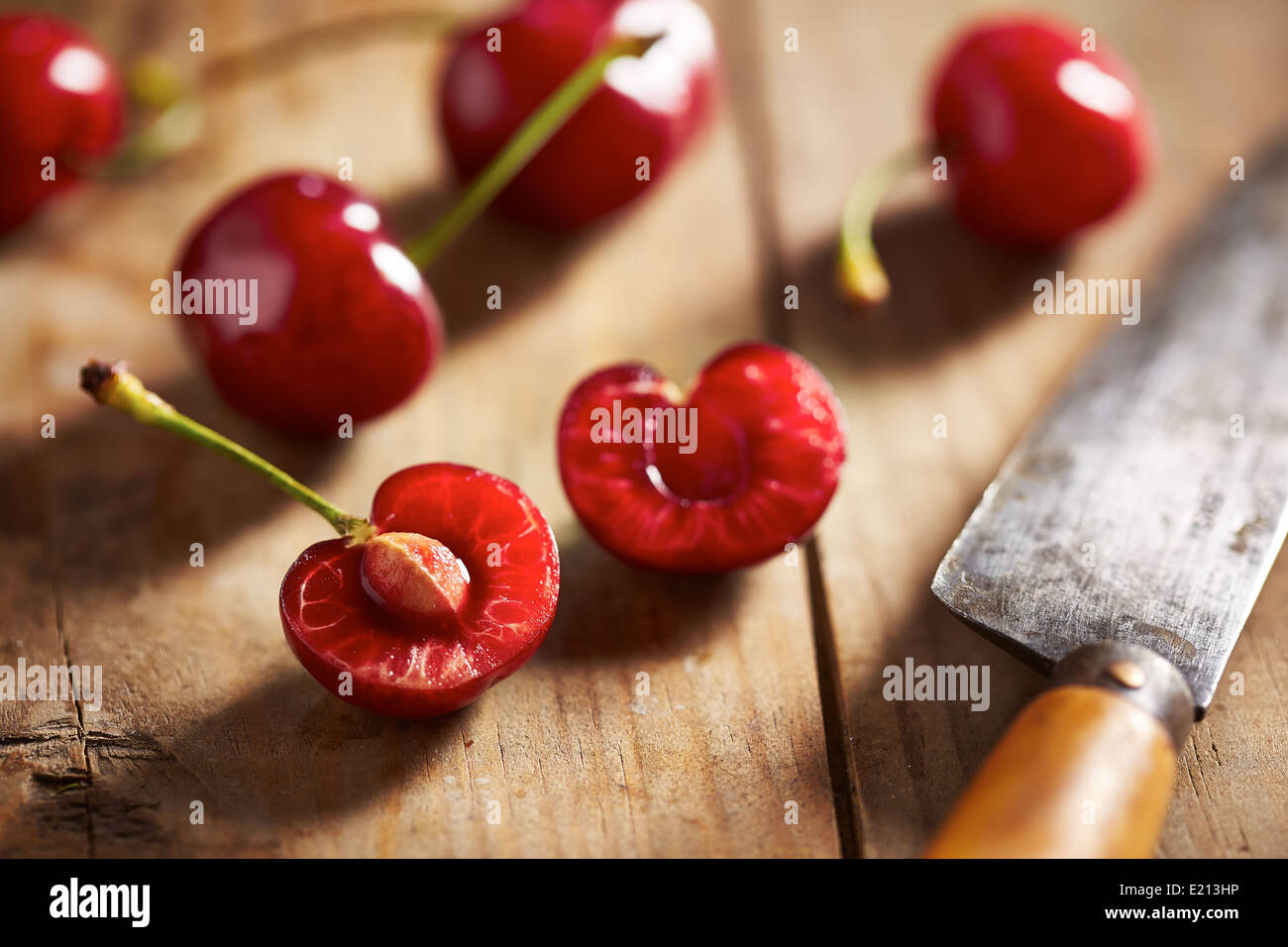 Red ripe open cherry on wooden background Stock Photo