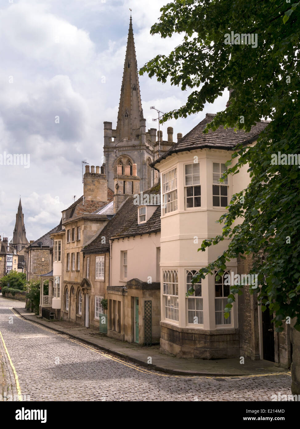 Old narrow cobbled street, stone houses and All Saints & St Mary's Church Spires, Barn Hill, Stamford, Lincolnshire, England, UK Stock Photo
