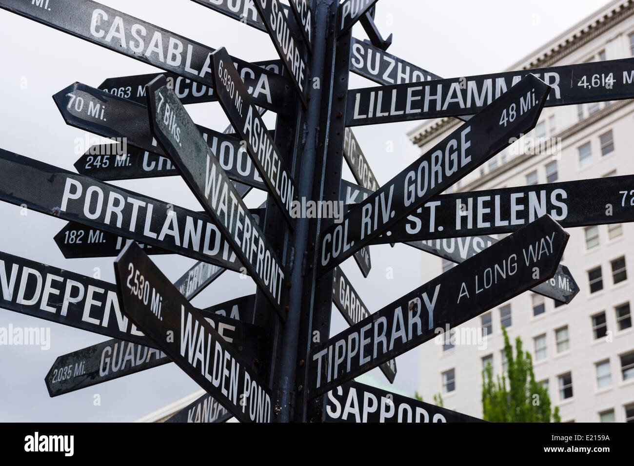 Famous signpost with directions to local and world landmarks at Pioneer Courthouse Square, Portland, Oregon, United States. Stock Photo