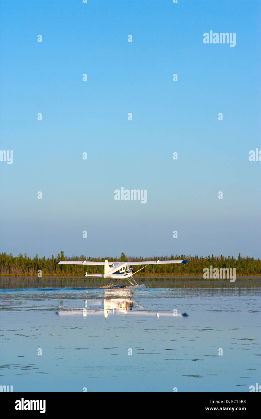 A floatplane landing on a small lake Stock Photo