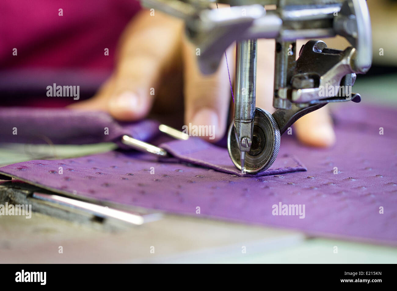 Close up shot of the detail involved of machine stitching leather bags