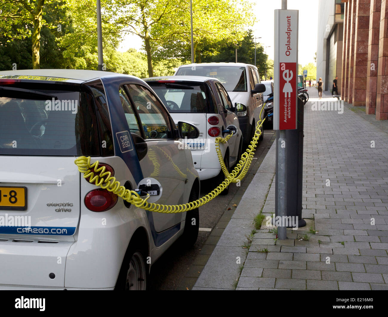 Electric Smart cars charging on the Zuidas in Amsterdam, the Netherlands Stock Photo