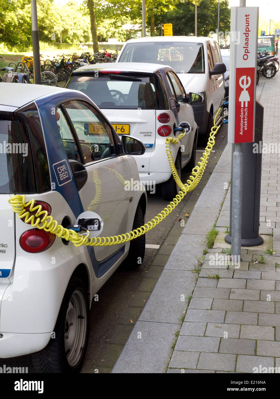 Electric smart cars charging on the Zuidas in Amsterdam, the Netherlands Stock Photo