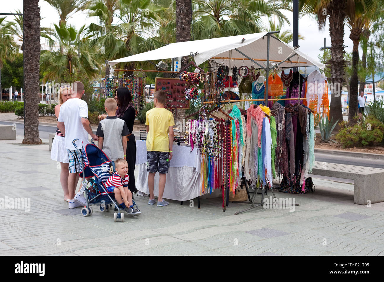 market trader bargaining with a family in Ibiza Stock Photo