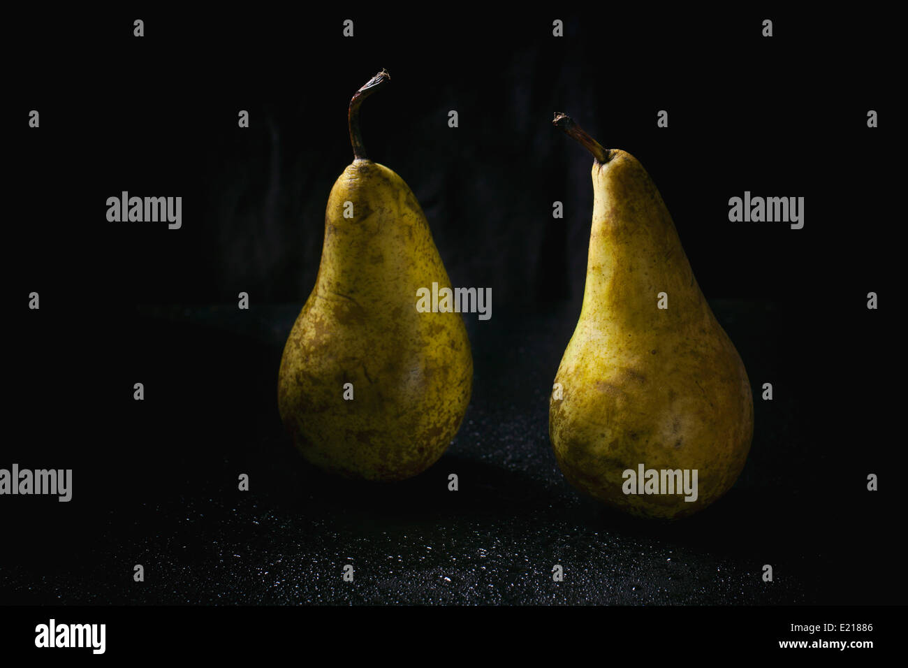 Two pears over wet black background Stock Photo